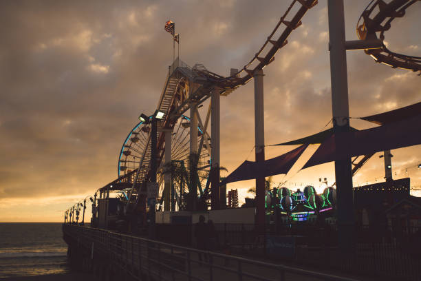 istock Ferris Wheel By Sea Against Sky During Sunset 755763233