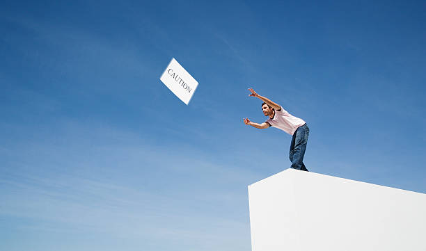 Man throwing caution to the wind  signs and symbols stock pictures, royalty-free photos & images