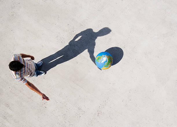 Aerial View of man with shadow and globe  illusion photos stock pictures, royalty-free photos & images