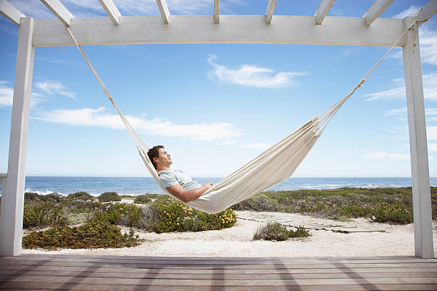 Man sleeping in a hammock  hammock stock pictures, royalty-free photos & images