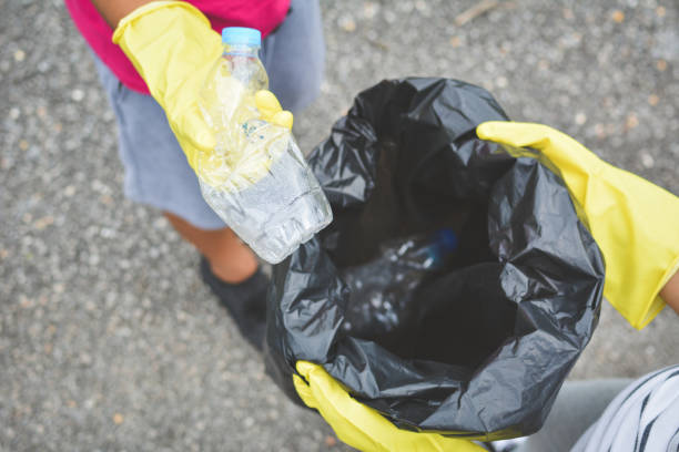 istock High Angle View Of People Holding Crushed Bottle And Garbage Bag While Standing On Street 758480259