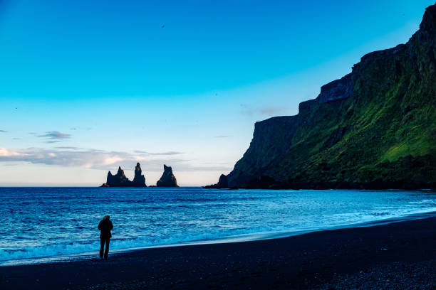 istock Silhouette Person Standing On Shore Against Sky At Beach 758528773