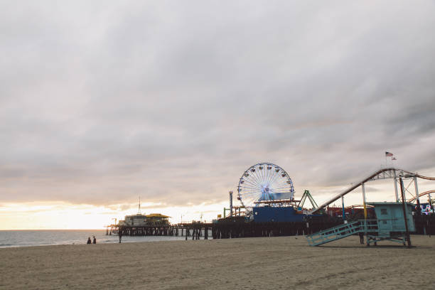 istock Santa Monica Pier At Beach Against Cloudy Sky During Sunset 758532625