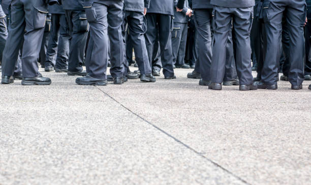 istock Low Section Of Police Force Standing On Road 758535127