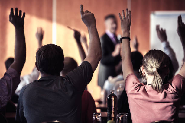 istock Audience With Arms Raised In Lecture Hall During Seminar 758587809