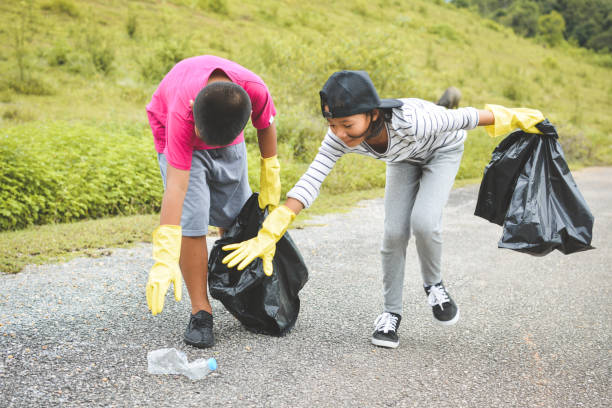 istock Volunteers Collecting Garbage On Road 758615017