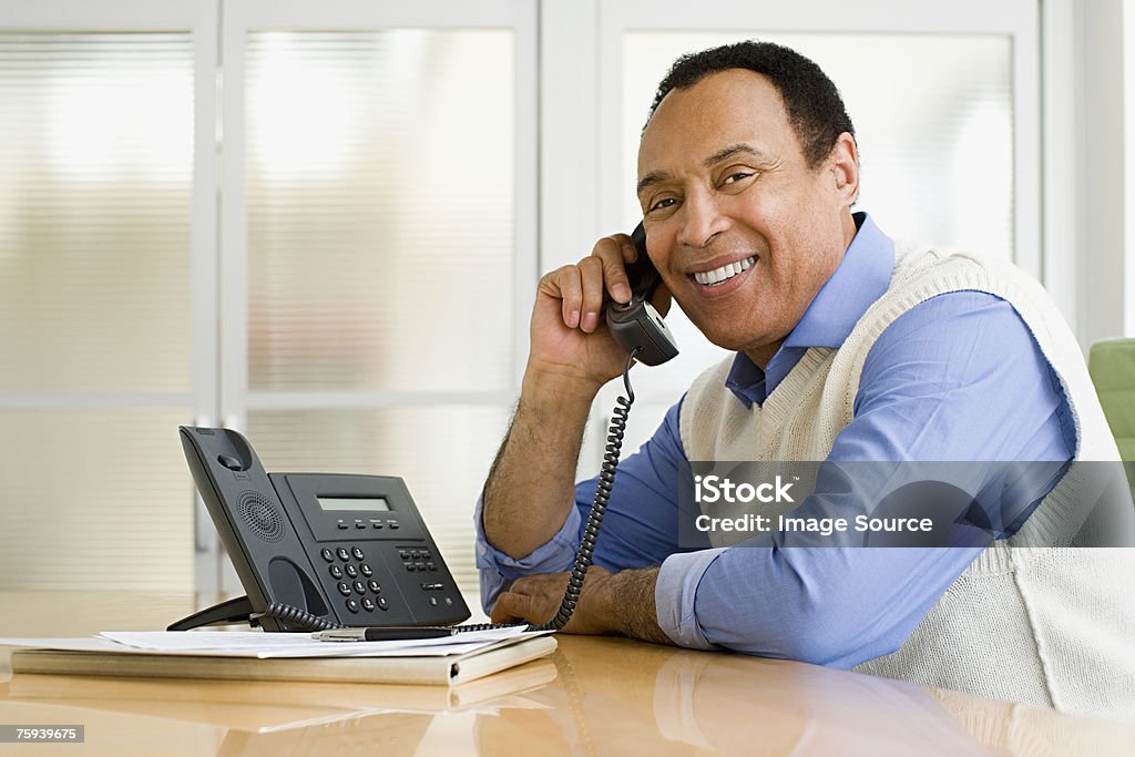 Man on telephone  Desk Stock Photo