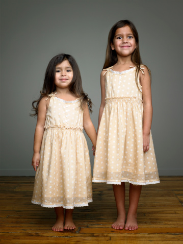 Portrait of happy smiling two little sister girls children together in summer park