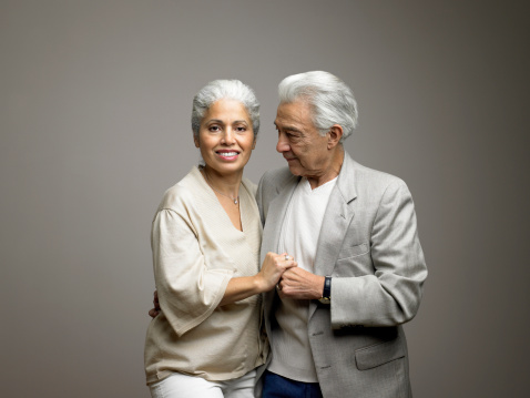 Asian Older male and females people dance with their partners on a dancing floor in living space.