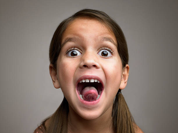 girl sticking out tongue - mensentong stockfoto's en -beelden