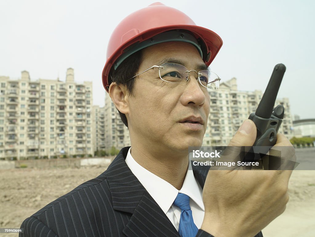 Man on building site with walkie talkie  Adults Only Stock Photo