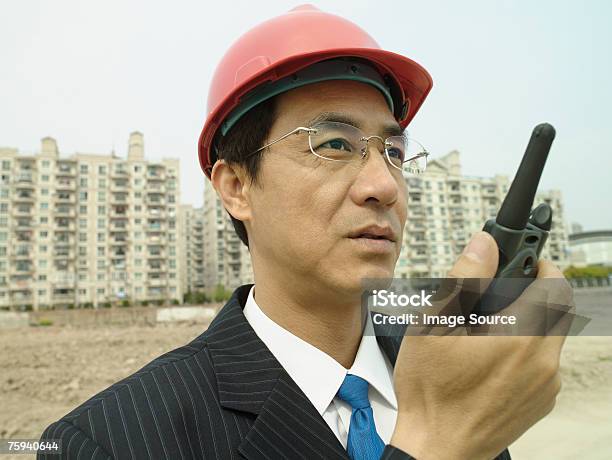 Man On Building Site With Walkie Talkie Stock Photo - Download Image Now - Adults Only, Architect, Architecture