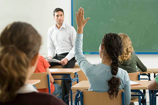 Teacher asking question  hand raised classroom student high school student stock pictures, royalty-free photos & images