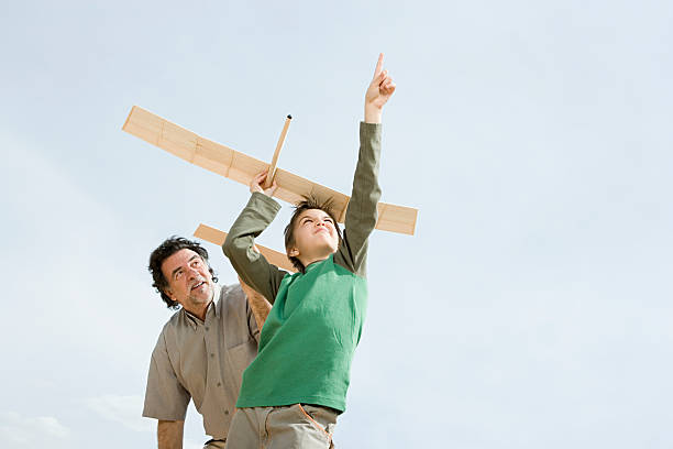 Boy and grandfather with toy aeroplane  toy airplane stock pictures, royalty-free photos & images