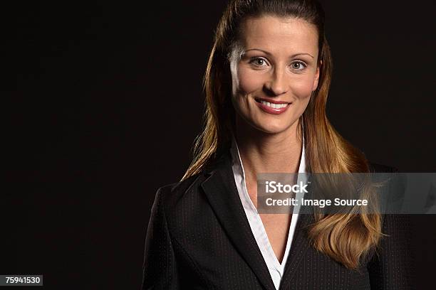 Portrait Of A Businesswoman Stock Photo - Download Image Now - Black Background, Portrait, Business
