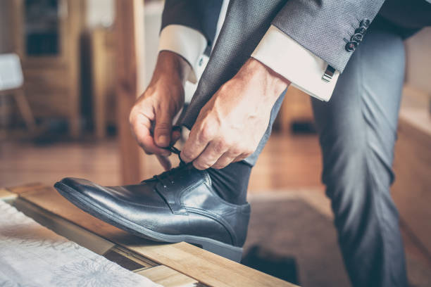 istock Low Section Of Man Tying Shoes 760273699