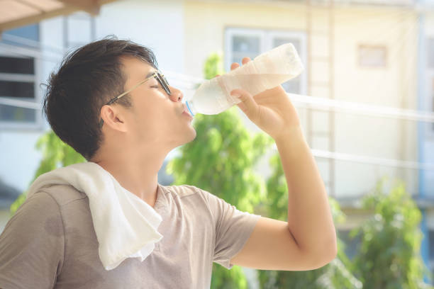 istock Side View Of Man Drinking Water From Bottle 763245141