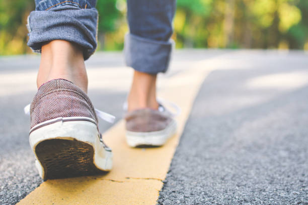 istock Low Section Of Woman Walking On Road 763264805