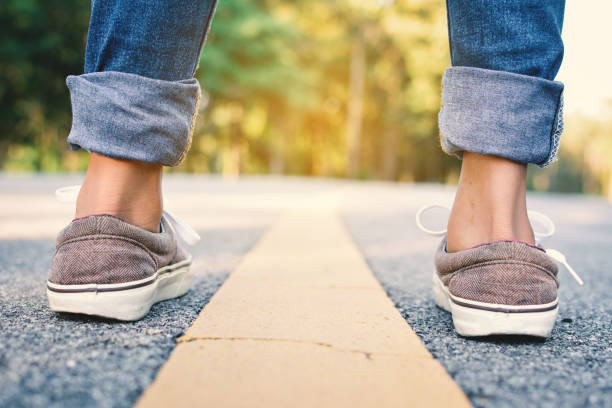 istock Low Section Of Woman Standing On Road 763267413