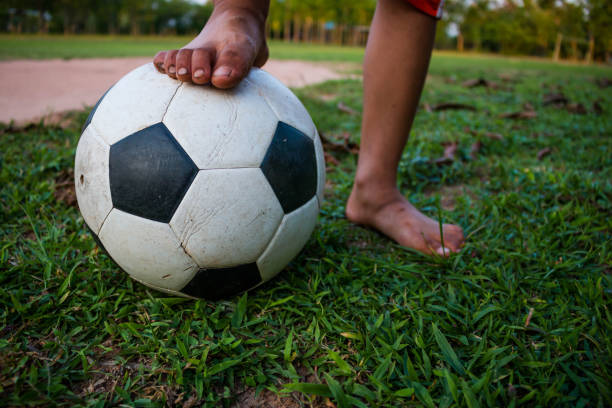 istock Low Section Of Child Playing Soccer On Grass 763268589