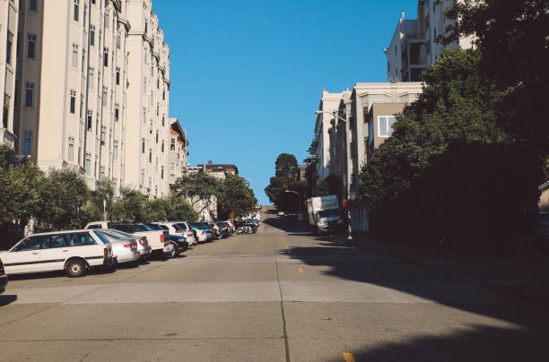 istock Cars Parked On Road Against Clear Blue Sky 766402279