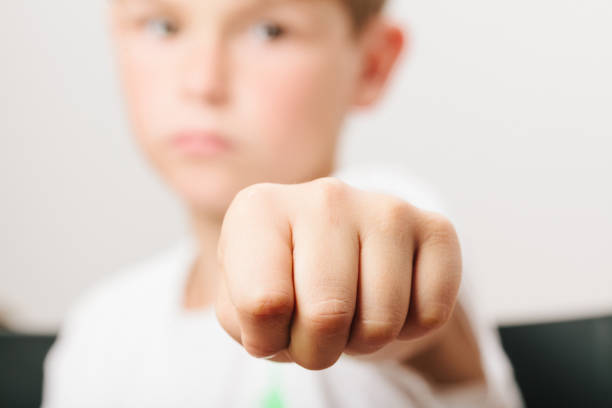istock Close-Up Of Boy Gesturing Fist 766412017