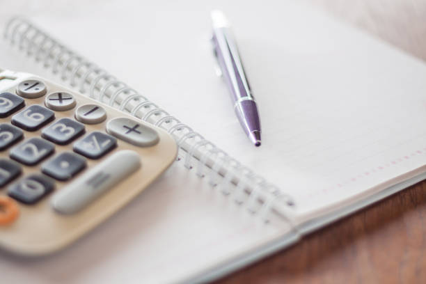 istock Close-Up Of Calculator With Pen And Book On Table 767987643
