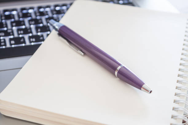 istock Close-Up Of Computer Keyboard With Book And Pen On Table 767989453