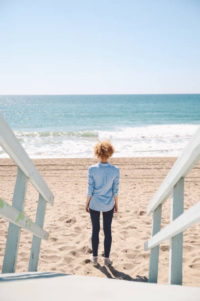 istock Rear View Of Woman Standing At Beach 768021991