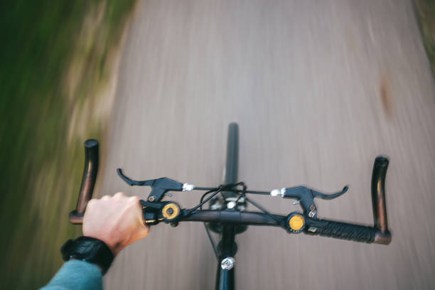 istock Cropped Hand Of Man Riding Bicycle On Road 769772517