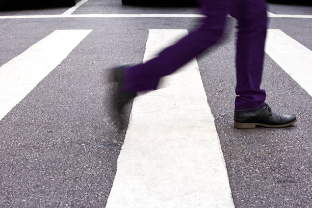 istock Low Section Of Man Walking On Zebra Crossing 769777139