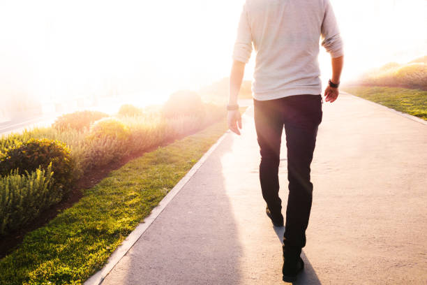 istock Low Section Of Man Walking On Road 769782679