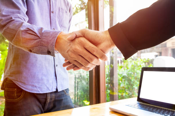 istock Close-Up Of Men Shaking Hands In Office 769819241