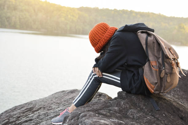 istock Girl Sitting Against Lake And Sky 771531431