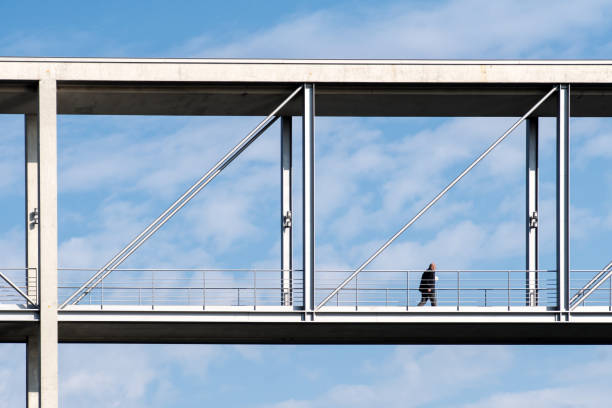 istock Low Angle View Of Mature Man Walking Bridge Against Cloudy Sky 771534765