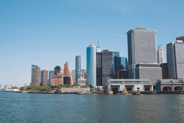 istock Skyscrapers By River Against Clear Blue Sky 771604479