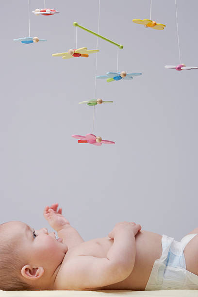 A baby playing with a mobile  hanging mobile stock pictures, royalty-free photos & images