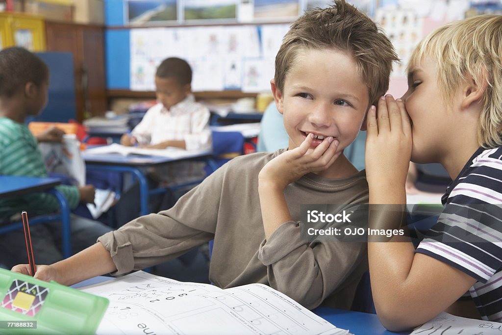 Students in class whispering  Whispering Stock Photo