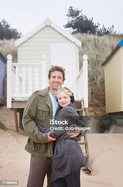 Una Pareja En La Playa Foto de stock y más banco de imágenes de 25-29 años - 25-29 años, Abrazar, Abrigo de invierno