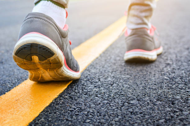 istock Low Section Of Person Walking On Road 773125479