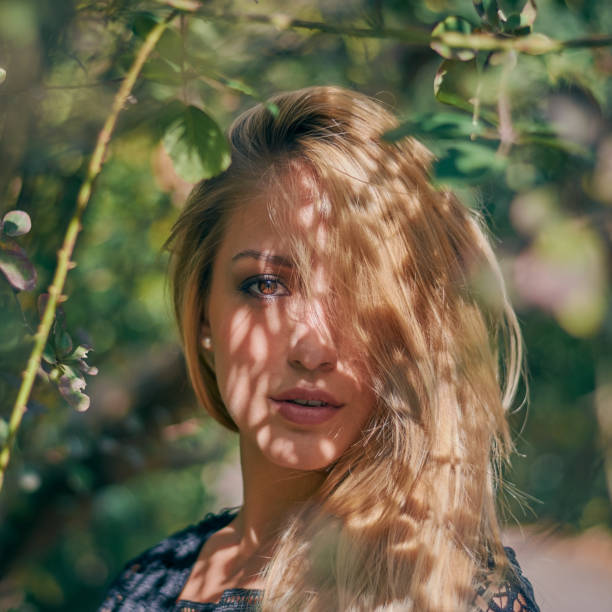 istock Portrait Of Young Woman Standing By Tree 773128711