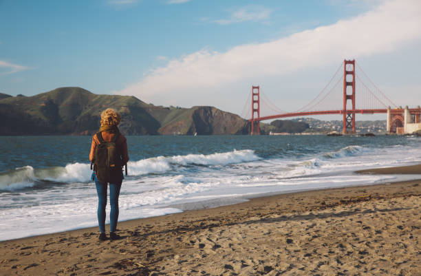 istock Woman Standing On Shore With Golden Gate Bridge In Background 773128723