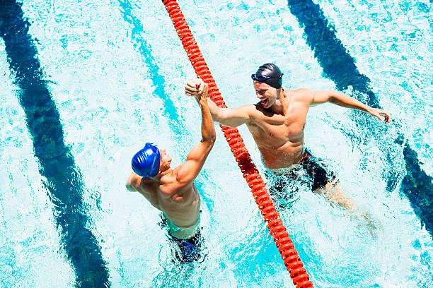 due nuoto in una piscina entrare le mani - team sport foto e immagini stock