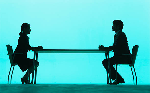 Businessman and businesswoman at a table  confrontation stock pictures, royalty-free photos & images