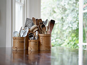 Kitchen utensils in containers on table