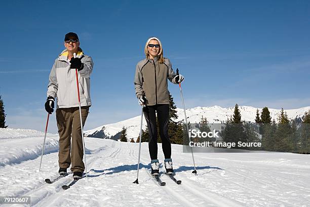 Couple Cross Country Skiing Stock Photo - Download Image Now - Men, Ski, Skiing