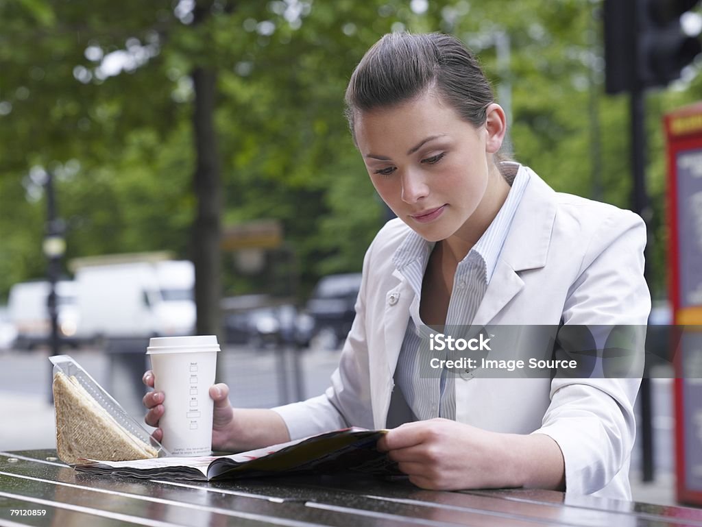 Junge Frau lesen Magazin - Lizenzfrei Bürojob Stock-Foto