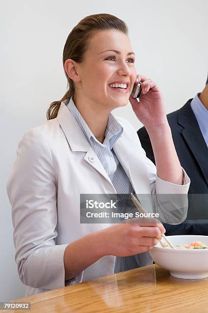Woman On Cellphone In Restaurant Stock Photo - Download Image Now - Adult, Adults Only, Bowl