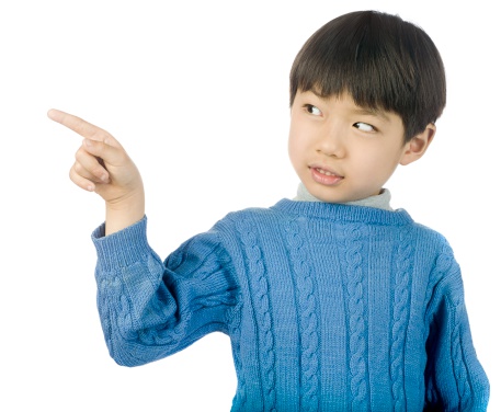 Portrait of Asian little boy show two forefinger pointing up and looking camera isolated on white background.