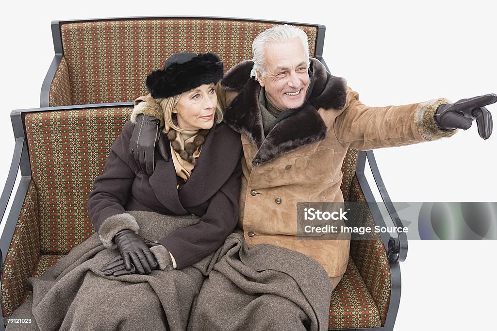 Portrait of a couple in a sleigh  Senior Couple Stock Photo